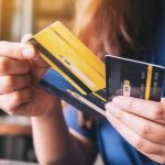 a_woman_holding_and_choosing_credit_card_to_use_picture_id1172101452-37034218