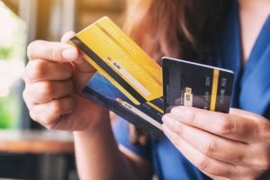 a_woman_holding_and_choosing_credit_card_to_use_picture_id1172101452-37034218