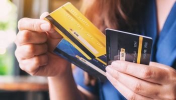 a_woman_holding_and_choosing_credit_card_to_use_picture_id1172101452-37034218
