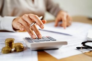 Business woman using calculator to manage finance